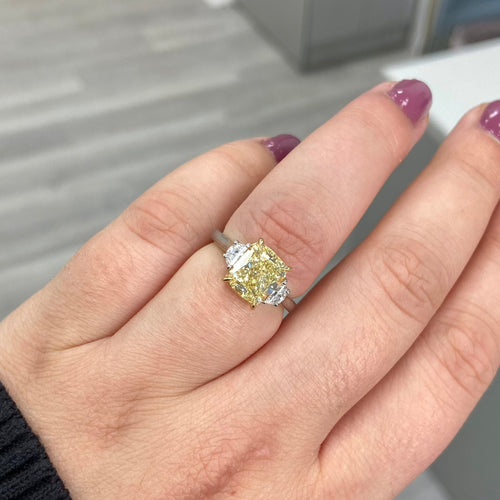 GIA yellow diamond, three stone ring. yellow diamond cushion. fancy light yellow. yellow diamond jewelry.