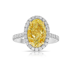 Old money yellow diamond ring with white halo. halo diamond engagement ring. fancy yellow oval. 3 carat oval diamond. yellow diamond engagement ring.