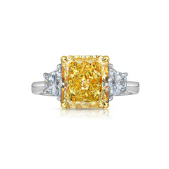 Old money 4 carat fancy yellow radiant set in 3 stone platinum ring.