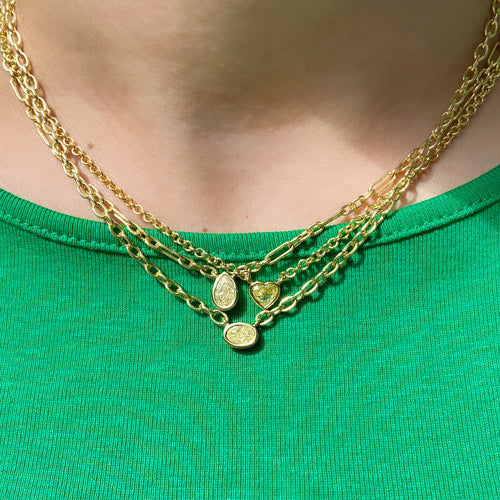 Canary diamond necklace, yellow oval cut diamond on a golden chain, bezel set yellow diamond