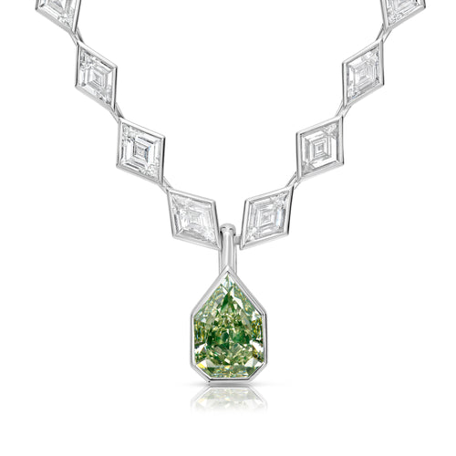 Diamond necklace with a green gemstone pendant on a white background