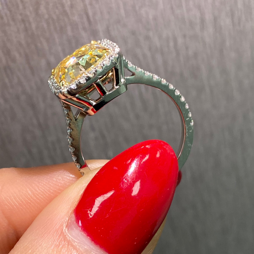 GIA certified natural canary yellow diamond ring surrounded by a halo of white diamonds.