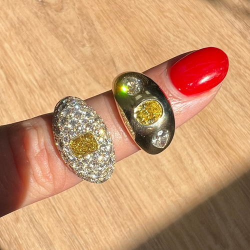 Elongated yellow diamond surrounded by white diamonds ring