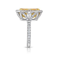 Luxurious yellow diamond ring with white halo diamonds and a SI1 clarity.