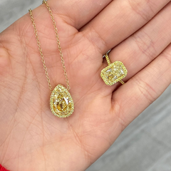 Elongated natural yellow diamond ring featuring a GIA-certified light yellow radiant diamond.