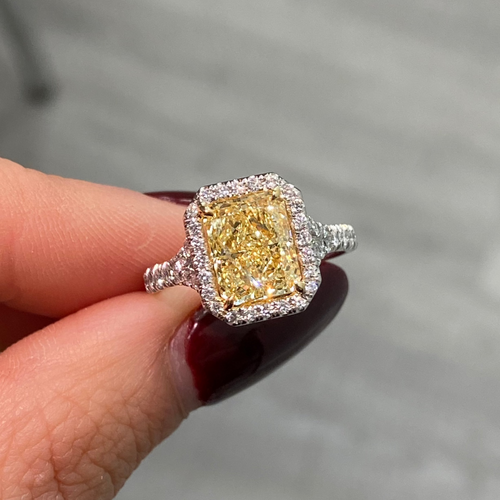 Old money yellow diamond ring with White Halo diamonds with a VS2 clarity.