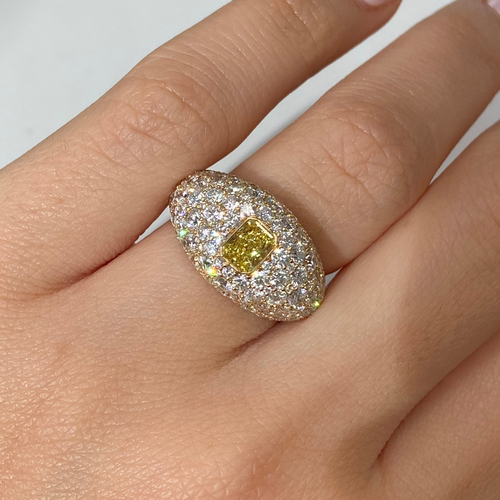 Elongated yellow diamond surrounded by white diamonds ring