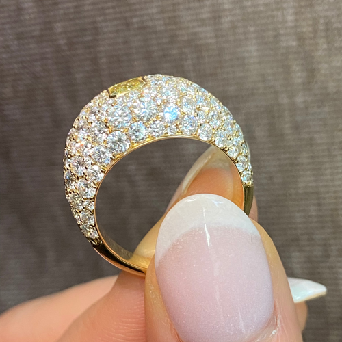Elongated yellow diamond surrounded by white diamonds ring