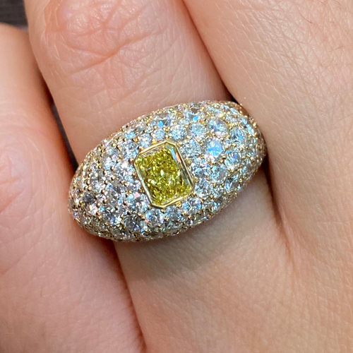 Elongated yellow diamond surrounded by white diamonds ring