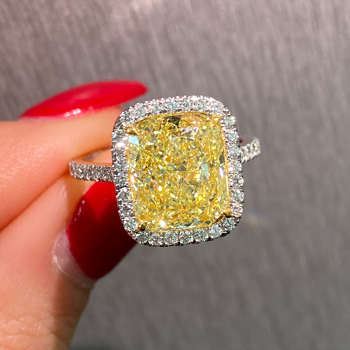 GIA certified natural canary yellow diamond ring surrounded by a halo of white diamonds.