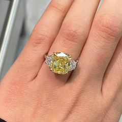 GIA certified three piece ring with fancy yellow cushion diamonds and natural yellow diamonds with VS2 clarity.