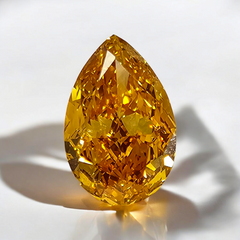 GIA certified fancy elongated yellow orange pear shaped diamond.
