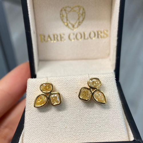 Celebrity style unique earrings with pear, radiant, and oval cut diamonds.