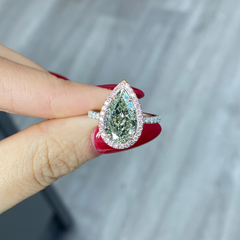 GIA certified fancy pear shaped green ring with pink diamonds.