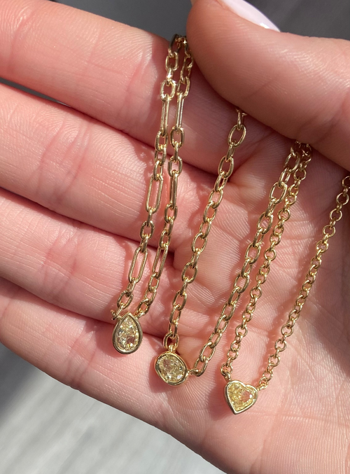 Canary diamond necklace, yellow oval cut diamond on a golden chain, bezel set yellow diamond