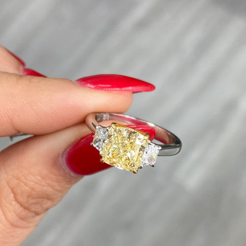 2.28 Carat Center Fancy Light Yellow Cushion Cut Diamond SI2 Clarity 0.32 Carats of E Color Trapezoids GIA Certified Diamond Crafted in Platinum and 18k Yellow Gold Handmade in NYC