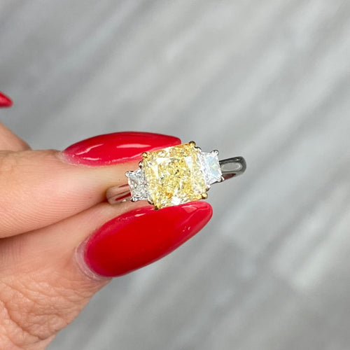2.28 Carat Center Fancy Light Yellow Cushion Cut Diamond SI2 Clarity 0.32 Carats of E Color Trapezoids GIA Certified Diamond Crafted in Platinum and 18k Yellow Gold Handmade in NYC