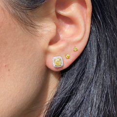 Fancy intense yellow cushion diamond studs with a F/VS2 clarity.