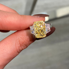 GIA certified fancy yellow elongated radiant diamond engagement ring with a striking center with a VVS2 clarity.