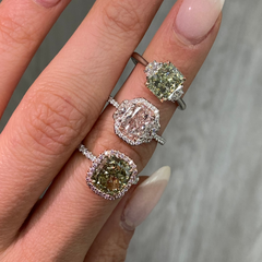 GIA certified greenish yellow cushion diamond in a pink halo engagement ring with VS1 clarity.