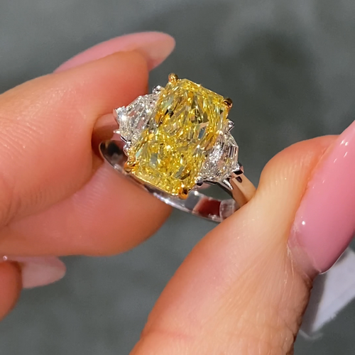 Fancy intense yellow elongated radiant cut ring female fingers
