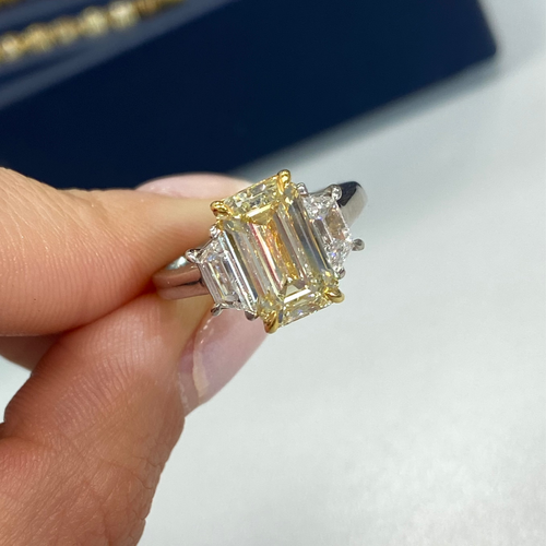 Light yellow emerald-cut diamond ring with excellent cut, VS2 clarity, and GIA certification.