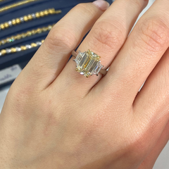 Light yellow emerald-cut diamond ring with excellent cut, VS2 clarity, and GIA certification.