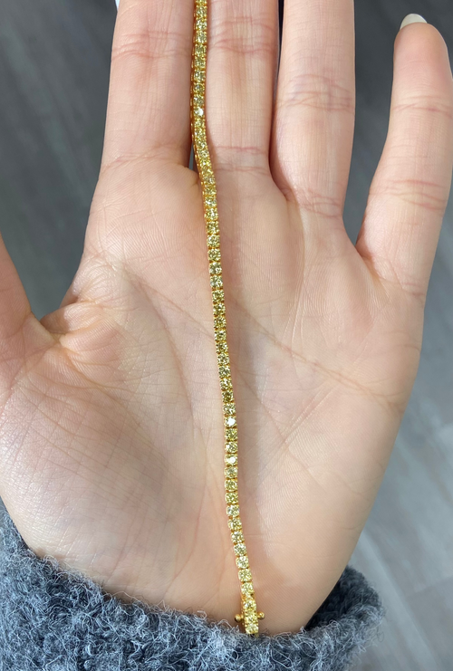 Fancy round shaped intense yellow diamond tennis bracelet, GIA certified with VS clarity.