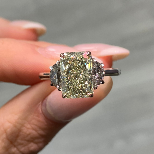 GIA-certified greenish yellow diamond ring with a radiant cut center stone and VVS2 clarity.