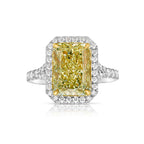 Light yellow radiant cut diamond engagement ring with a white diamond halo, VS2 clarity.