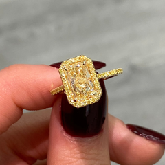 Elongated natural yellow diamond ring featuring a GIA-certified light yellow radiant diamond.