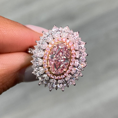 Fancy natural light pink elongated cushion cut set in white diamond white gold ring.