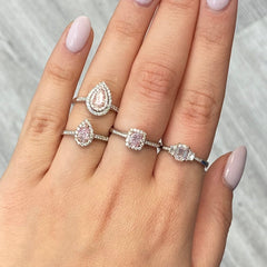 Pink diamond ring. pink diamond engagement ring. light pink diamonds. light pink cushions. diamond ring.