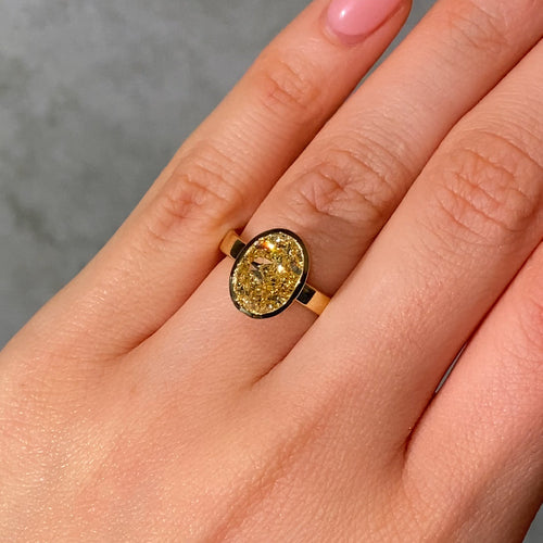 3.65ct Oval Fancy Light Yellow Diamond Bezel Engagement Ring