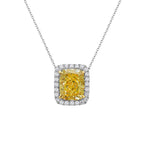 Natural fancy light yellow cushion cut diamond in a white diamond halo on a 18k gold pendant.