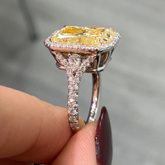 Luxurious yellow diamond ring with white halo diamonds and a SI1 clarity.