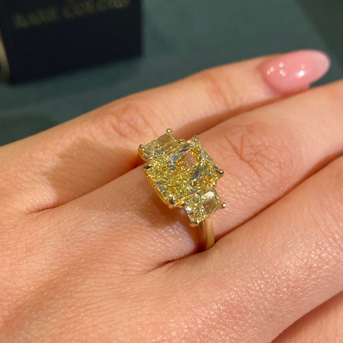 3 Yellow diamond ring on a female hand