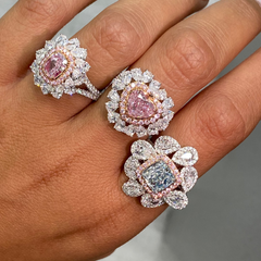 Pink heart shape diamond with white and pink surrounding diamonds.