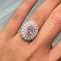 Fancy natural light pink elongated cushion cut set in white diamond white gold ring.