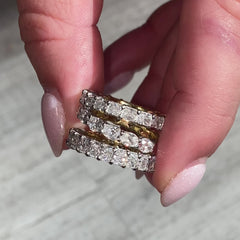 This handmade eternity band features a unique design with half of the band in yellow diamonds and the other half in white diamonds. The diamonds are set in a secure prong setting, showcasing their brilliance and fire. Perfect for giving you two styles in one ring.