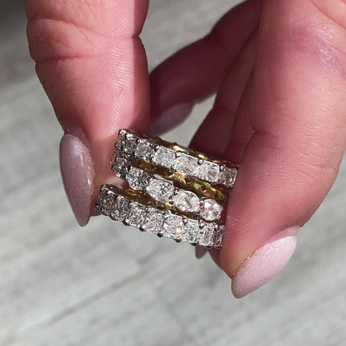 This handmade eternity band features a unique design with half of the band in yellow diamonds and the other half in white diamonds. The diamonds are set in a secure prong setting, showcasing their brilliance and fire. Perfect for giving you two styles in one ring.