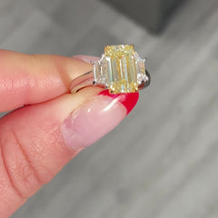 Light yellow emerald-cut diamond ring with excellent cut, VS2 clarity, and GIA certification.