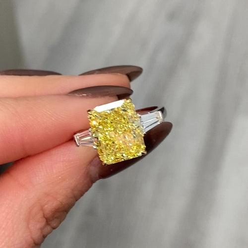 Luxurious yellow elongated radiant diamond engagement ring with a stunning hue with a VVS2 clarity.