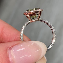 GIA certified greenish yellow cushion diamond in a pink halo engagement ring with VS1 clarity.