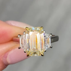 Light yellow emerald-cut diamond ring with excellent cut, VS2 clarity, and GIA certification.