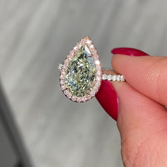 GIA certified fancy pear shaped green ring with pink diamonds.