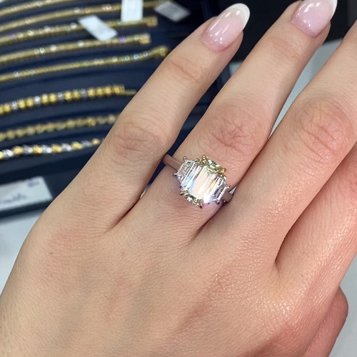 Light yellow emerald-cut diamond ring with excellent cut, VS2 clarity, and GIA certification.