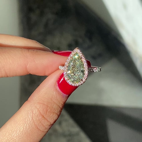 GIA certified fancy pear shaped green ring with pink diamonds.