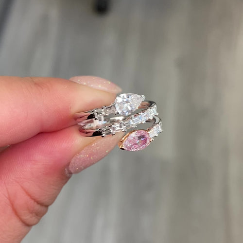 pink diamond statement ring, pink and white pear shape diamonds with emerald cut diamonds along the band
