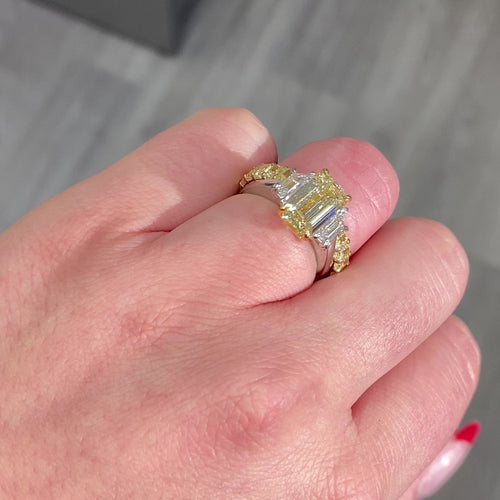 Light yellow emerald-cut diamond ring with excellent cut, VS2 clarity, and GIA certification.